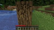 Punching a tree for a wood log in Minecraft. (Image via Minecraft)